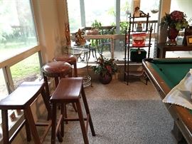 Bar stools, bistro table with wine rack.