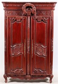 Lot#28, FRENCH CARVED WALNUT, ARMOIRE, H 83", L 56", D 26"Having carved crown moldings with carved wreath of leaves and berries. Above two carved panel doors opening to three shelves. 3/4 round fluted columns at the front corners and a center half round fluted column attached to one door forming a center accent between the two doors when closed. Long narrow brass lock bezels on each door. Contoured carved skirt at the front and sides. On carved  feet and the front and bracket feet at the back.
