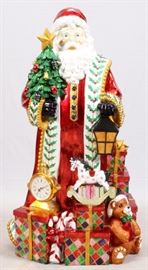 Lot#42, CHRISTOPHER RADKO SANTA CLAUS FIGURE, H 60", W 33", D 26"A glittering form of Santa Claus, surrounded by toys and presents, with a clock mounted at his lower right.