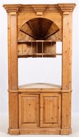 Lot#83, KNOTTY PINE CORNER CABINET, H 91", W 50", D 20"Having upper dentil molding, full fluted columns, coved upper shelving, and sits atop two wooden paneled doors opening to a contoured shelf. From the Estate of Daniel Clancy, Voltaire Place, Grosse Pointe Farms.