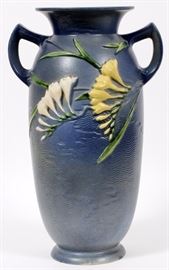 Lot#92, ROSEVILLE, 'FREESIA', POTTERY VASE, #128-15, H 15"'Freesia' design on a blue ground with yellow and white flowers. Signed "Roseville U.S.A." and "128-15"