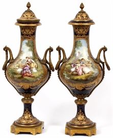 Lot#1001, SEVRES FRENCH PORCELAIN VASES, 19TH.C., PAIR, H 23", W 9", SIGNED L BERTREN.Cobalt blue, reserves with courting figures and verso with hand painted French landscapes, signed L. Bertren.  Heavy gold gilding.  Bronze mounts. Loose covers. Sevres underglaze blue trademark on bases.