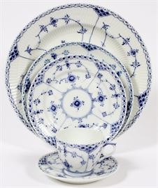 Lot#1006, ROYAL COPENHAGEN BLUE FLUTED LACE DINNER SERVICE, 64 PIECES.Closed lace. Fourteen plates #165-1C 10", twelve plates 7 5/8", fourteen plates 6 3/4", thirteen saucers 5 1/4", eleven cups.