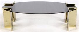 Lot#1032, PACE COLLECTION, BRASS AND SMOKY GLASS COFFEE TABLE, H 17", W 60", D 30"Contemporary oval glass and brass. From the Estate of Jean Mayer, Bloomfield Hills, Mich.