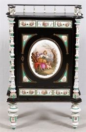 Lot#2002, MEISSEN MOUNTED & EBONIZED CABINET, 19TH.C. H 51 1/2", W 31 1/2', D 15"Germany, 19th.c. H 51 1/2", W 31 1/2', D 15". Single door with important oval porcelain plaque depicting blind man's bluff, H 16" x W 12 3/4". Upper gallery with porcelain spindles, two drawers with three porcelain panels each for a total of six. . Four free standing porcelain columns at corners. Raised on porcelain feet. Black ebony case. H 51 1/2", W 31 1/2', D 15"