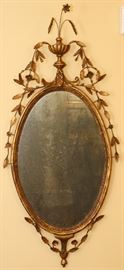 Lot#2093, ADAMESQUE GILT GESSO OVAL MIRROR, C. 1785, H 41", W 16 1/2"An oval gilt gesso frame surmounted by an urn surrounded by foliage, wheat and flowers.  Provenance: David Stockwell, Inc., Wilmington, DE, purchased in December 1983.