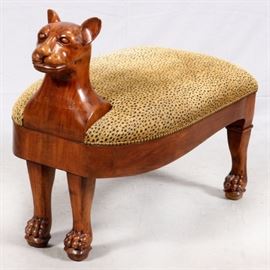 Lot#2229, CARVED WALNUT CHEETAH FORM BENCH, H 30", W 37"A figure of a cheetah with cheetah print upholstery and brass nail head trim. From the Estate of Daniel Clancy, Voltaire Place, Grosse Pointe Farms.