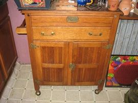 Microwave cart made to look like an old ice box.