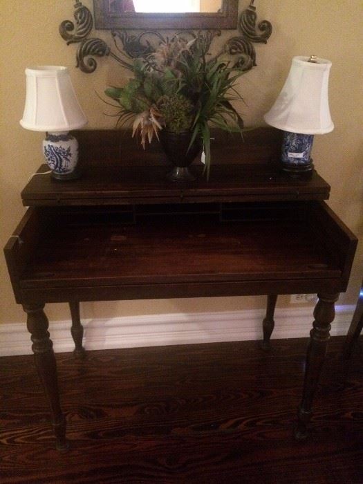 Small antique desk (top folds out); two small blue & white lamps; floral arrangement