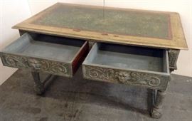 Antique Colonial Spanish Desk. Heavily Carved with Faux marble Painted Plank Top. (paint is chipped a bit).Beautifully carved Lion's Head on each Drawer. 56" x 35" x 31"