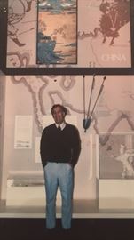 Artist, Albert Lane standing with his work while hanging at the National Air & Space Museum.