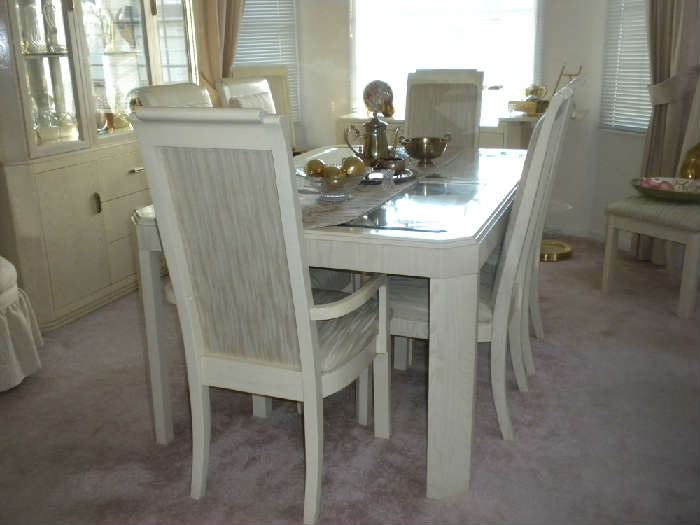 Table has 8 chairs plus a leaf and pads.  The top is mirror