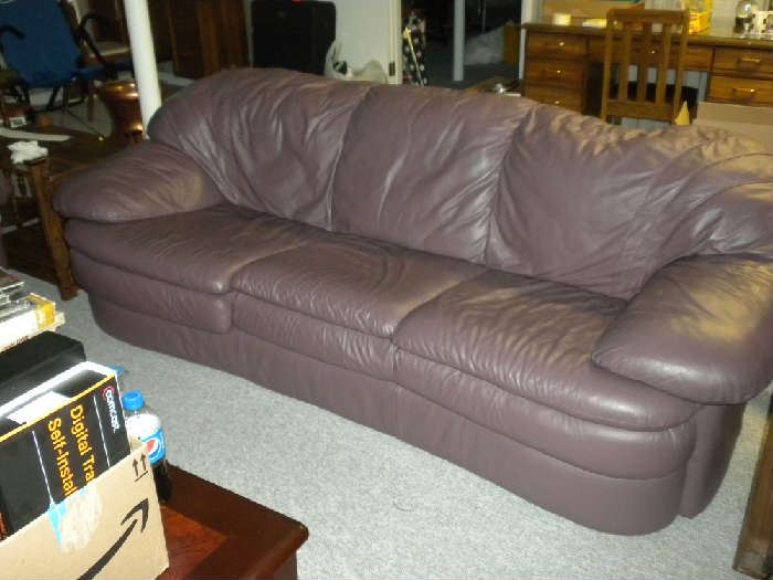 This leather sofa in a smoker purple color has a matching love seat and chair