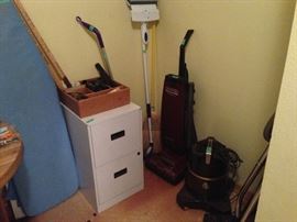 File cabinet, ironing board, rainbow vacuum