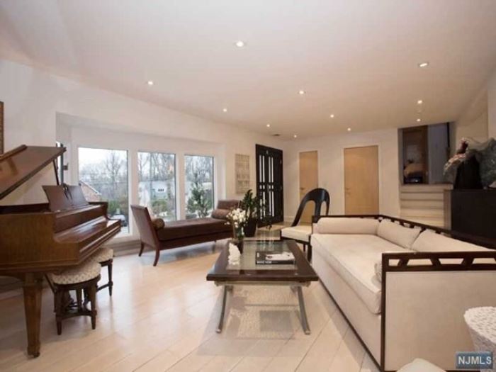 Knabe baby grand piano, Michael Weiss for Vanguard Furniture chaise, ultrasuede sofa, pair of ebonized gondola chairs, X base cocktail table