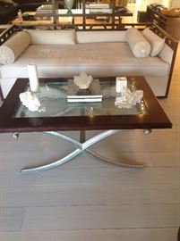 Beige ultrasuede sofa, X metal base cocktail table, pair of Chinese stone carvings