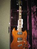 A vintage Guild 6 string electric guitar with case.