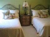 A great pair of grey metal frame full sized beds. An oval faux painted 3 drawer side table/nightstand.