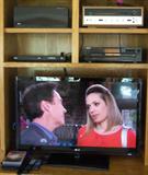 LG HDTV, Vintage Sansui 5000X receiver, newer electronics.