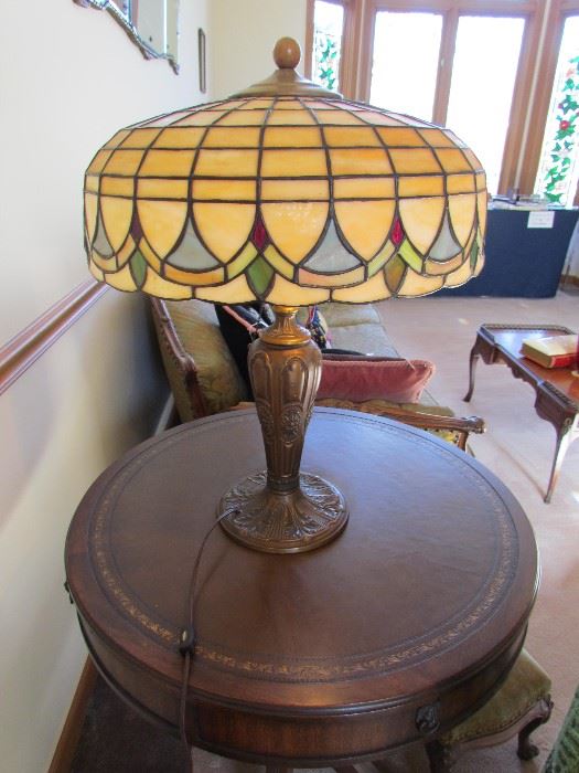 LEADED SLAG GLASS LAMP SHADE WITH PERIOD BASE.  ROUND DUNCAN PHYFE LEATHER TOP LAMP TABLE 