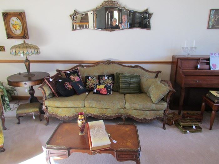 FRENCH PROVINCAL SOFA.  OVER SOFA WALL HUNG FANCY TRI-MIRROR, COFFEE TABLE, SPINET PIANO AND BENCH, SLAG LEADED GLASS TABLE LAMP ETC. 