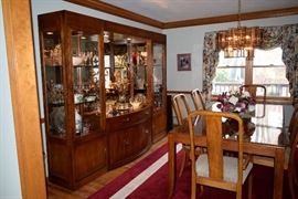 table, 2 arm chairs, 4 side chairs, china buffet, sideboard, custom table covers, area rug, Red Oak Solids with Knotty Oak Veneers which finishes in a rich Chestnut that compliments a range of color treatments and design themes.