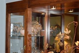 dimming lights, gleaming bronzed glass, glass shelves