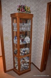 small lighted display case with ceramic box collection