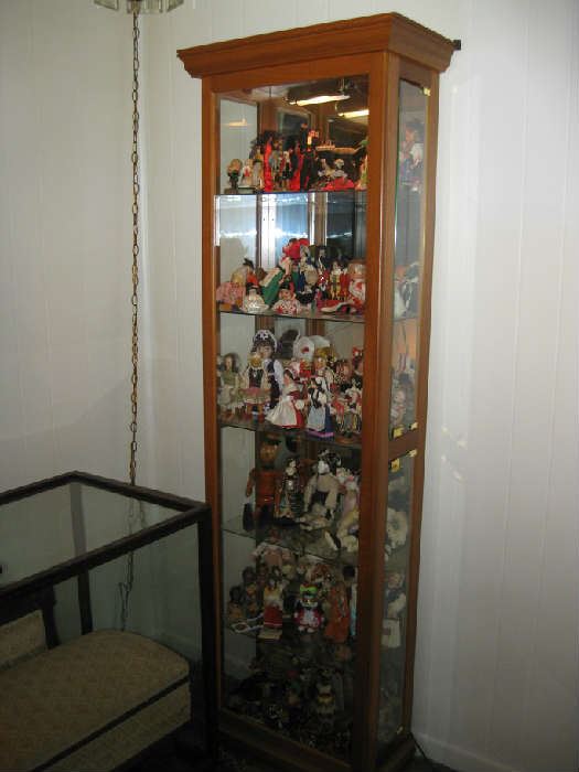 curio cabinet full of dolls