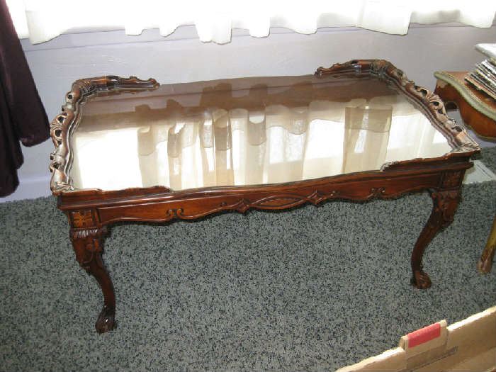 carved coffee table with glass insert