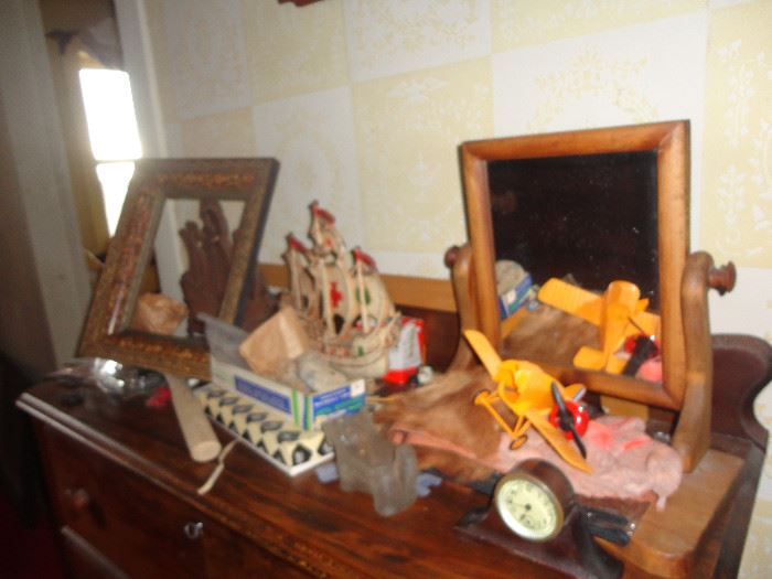Pair of door stops - flag ships with  masts.  Wood framed dresser mirror, toy airplane and small clock.