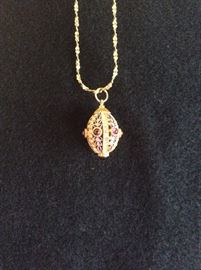 14K pendant with enamel and red sets   Resembles a Faberge egg   Beautiful 14K chain 