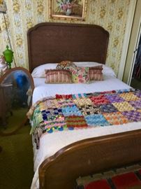 Tiger oak headboard on this antique bed . Beautiful oak framed oval mirror to the left of the bed.