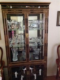 Oriental China Cabinet with inlaid pearl.  Crystal stemware and vases.
