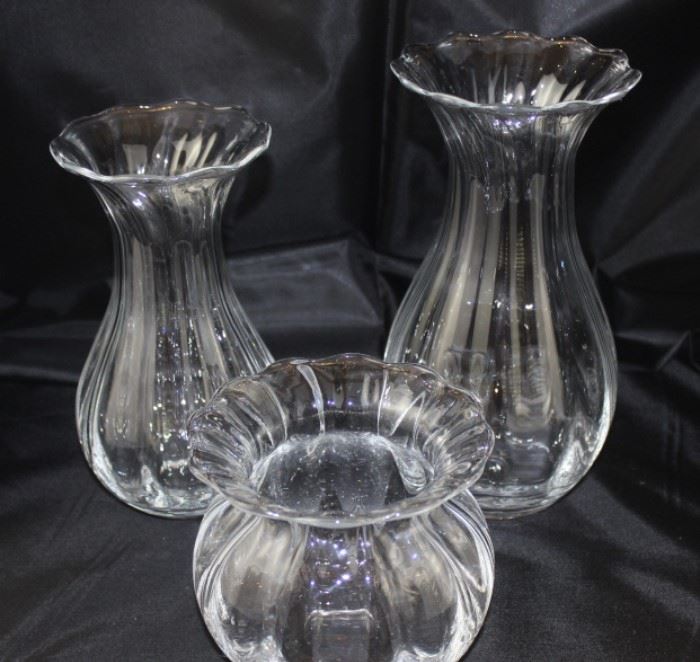 Three hand blown clear glass vases. Measures, tallest one is 9"H, second tallest is 8"H and short one is 4.75"H.