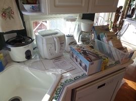 assorted small kitchen appliances and cookbooks