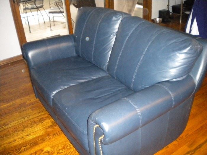Blue leather loveseat with nailhead trim