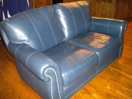 Blue leather loveseat with nailhead trim