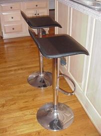 Pair of black leather stools with chrome bases to go with previous table