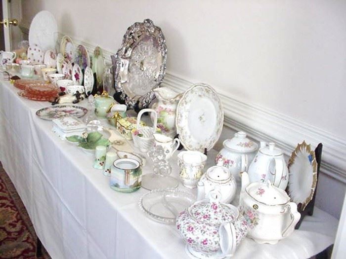 Lots of teapots, pitchers, decorative plates, trays, cups and saucers