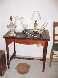Marble top table, antlers, lamps, wash bowl and pitcher, cast iron kettle