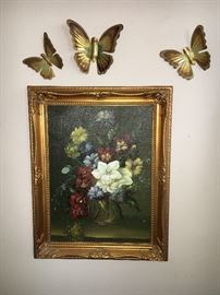 Floral oil painting and metal butterflies.