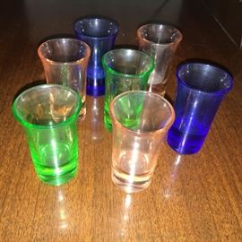 7 colorful vintage shot glasses.