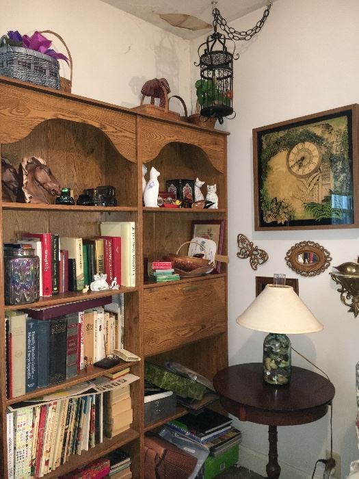 Two pressed wood bookcases and decor.