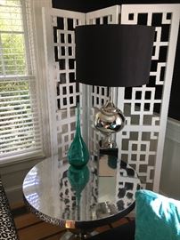 These versatile chrome tables are a wonderful accent. Add to that this sleek table lamp with chrome base -- behind that is a fab architectural room divider that adds tremendous interest!