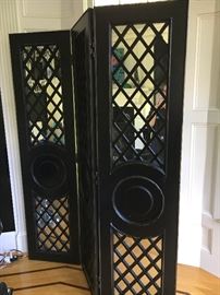 Substantial mirrored 3-panel screens with heavy ebonized wood panels and hatch cross pattern adorned with medallion shaped circles. 