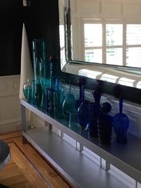 Console table, paper standing lighting in corner.