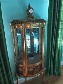 Lovely late 19th century serpentine Vernis Martin style French Vitrine Display Cabinet in gilded finish with glazed doors and interior glass shelves.