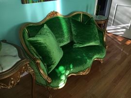 This is the real deal. 19th century, upholstered in emerald green to match the bed, this sofa is genuine gold leaf.
