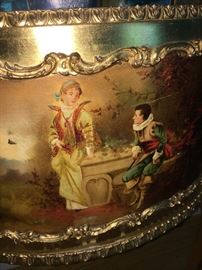 Painted image depicts fair maiden with young gent.